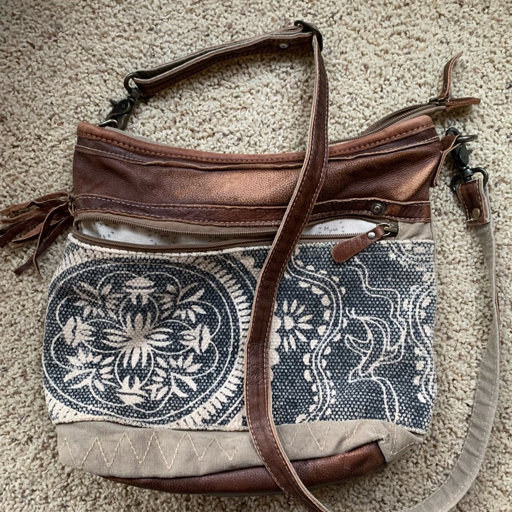 Myra Bag with crossbody strap. Good condition. Measures 11” tall by 14” wide.